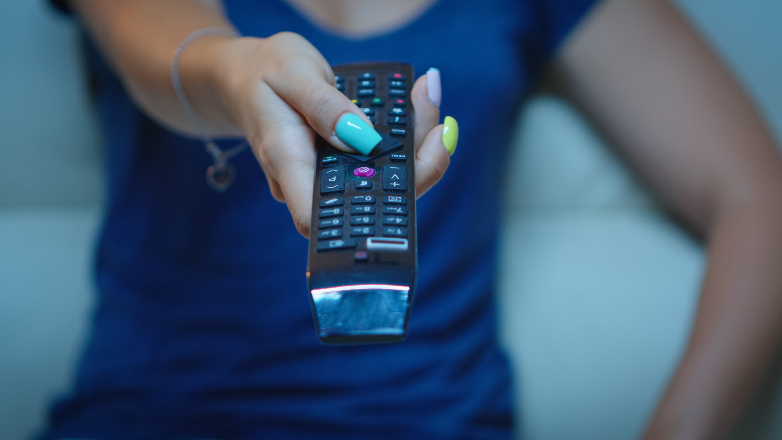 Close up of hand changing TV channels